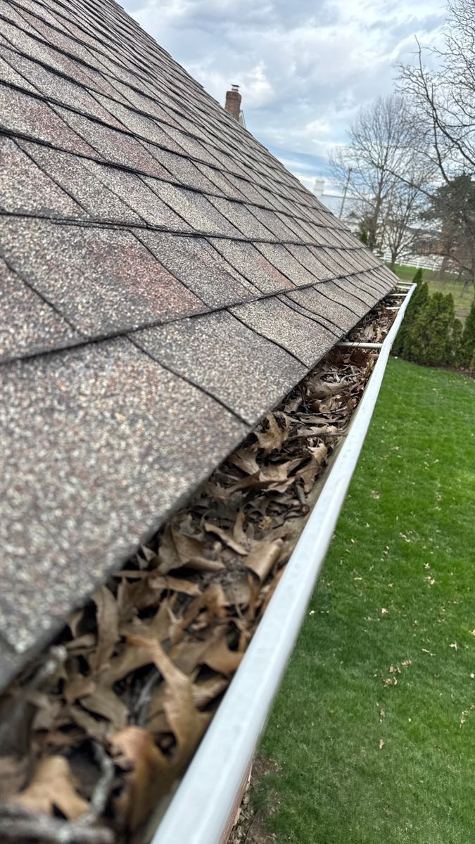 Long gutter run packed with dry leaves from end to end
