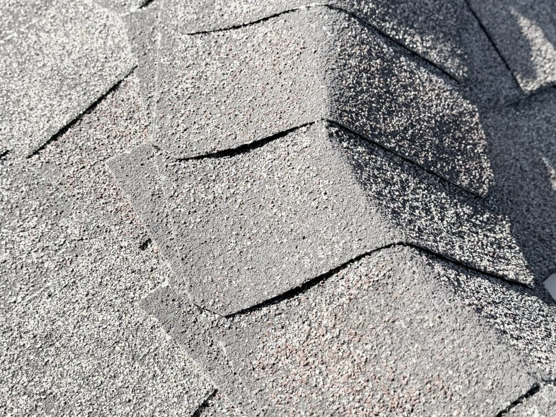 Hip cap shingles lapped up the hip of an asphalt shingle roof